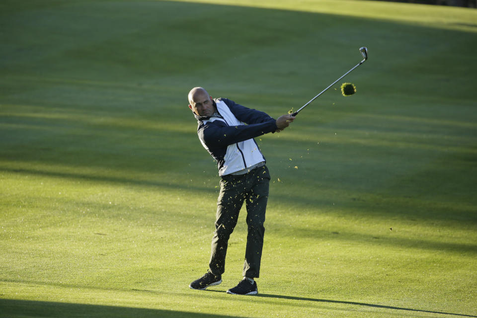 Pro surfer Kelly Slater follows his shot from the first fairway of the Spyglass Hill Golf Course during the first round of the AT&T Pebble Beach National Pro-Am golf tournament Thursday, Feb. 6, 2020, in Pebble Beach, Calif. (AP Photo/Eric Risberg)