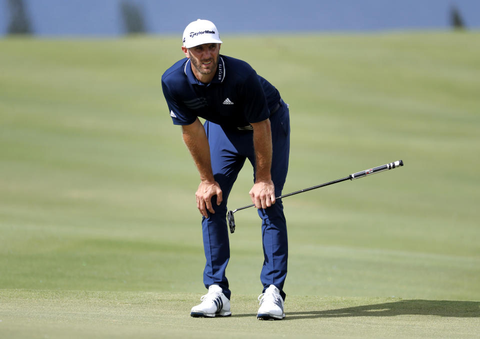 Dustin Johnson studies the putting green during the final round of the Tournament of Champions golf event in Hawaii. (AP Photo)