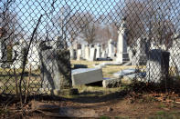 <p>Damaged headstones are seen through a hole in a fence surrounding Mount Carmel Cemetery Feb. 28, 2017, in Philadelphia. Scores of volunteers are expected to help in an organized effort to clean up and restore the Jewish cemetery where vandals damaged hundreds of headstones. (AP Photo/Jacqueline Larma) </p>