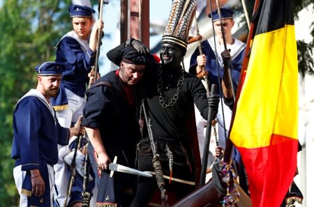 "The Savage", a white performer in a blackface disguise, parades during the festival Ducasse d'Ath in Ath