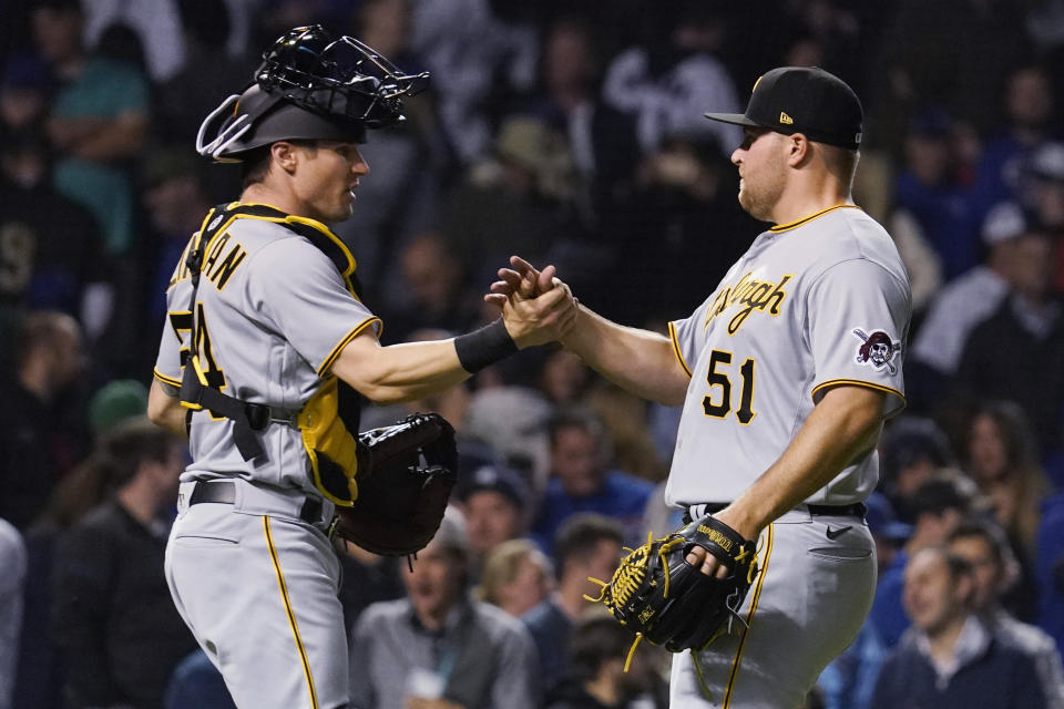 Pittsburgh Pirates relief pitcher David Bednar, right, celebrates with catcher Tyler Heineman after The Pittsburgh Pirates defeated the Chicago Cubs in a baseball game in Chicago, Wednesday, May 18, 2022. The Pirates won 3-2. (AP Photo/Nam Y. Huh)