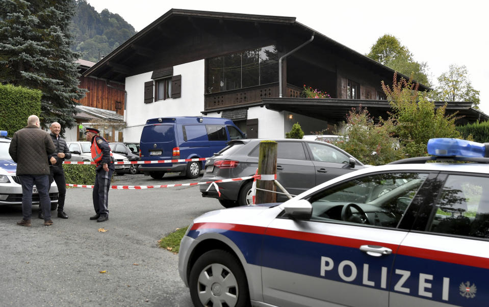 A police car is parked in front of a house in Kitzbuehl, Austria, Sunday, Oct. 6, 2019. Austrian police say a 25-year-old man's in custody after allegedly killing his ex-girlfriend, her family, and her new boyfriend in the Alpine resort town of Kitzbuehel. The 25-year-old turned himself to police in the town east of Innsbruck and admitted to the five slayings early Sunday morning, Austrian news agency APA reported. (AP Photo/Kerstin Joensson)