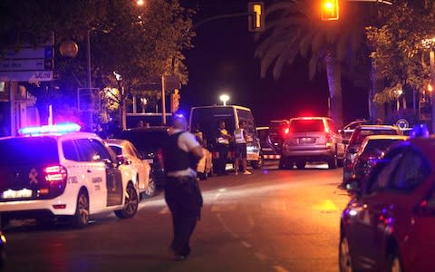 Spanish policemen patrol the street after five suspected terrorists were killed by the police in Cambrils - Credit: EPA