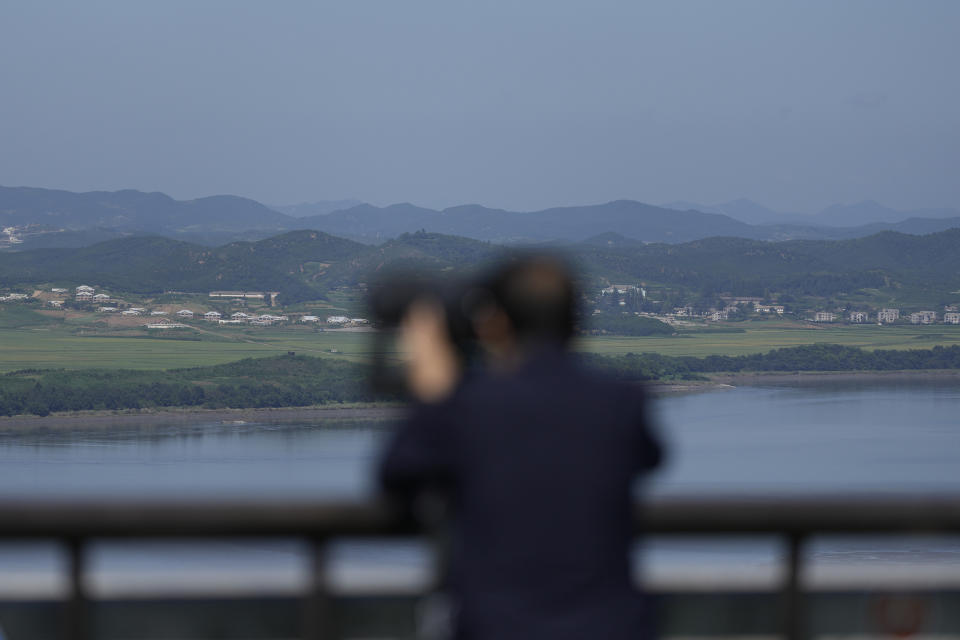 A visitor uses binoculars to see the North Korean side from the unification observatory in Paju, South Korea, Thursday, Sept. 8, 2022. South Korea's new government on Thursday proposed a meeting with North Korea to resume reunions of families separated since the 1950-53 Korean War, despite long-strained ties between the rivals over the North's nuclear weapons program. (AP Photo/Lee Jin-man)