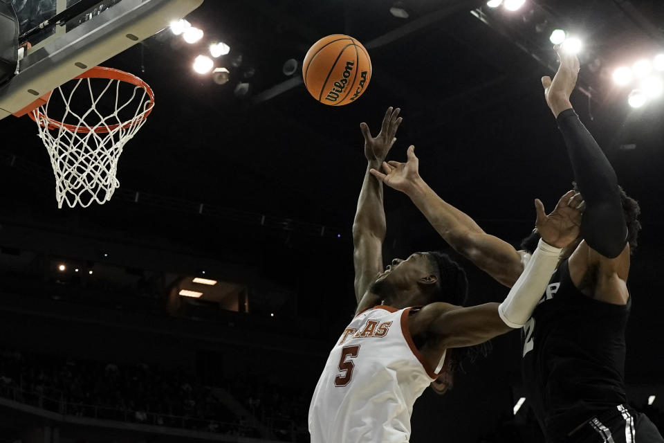 Texas guard Marcus Carr shoots past Xavier forward Jerome Hunter in the first half of a Sweet 16 college basketball game in the Midwest Regional of the NCAA Tournament Friday, March 24, 2023, in Kansas City, Mo. (AP Photo/Charlie Riedel)