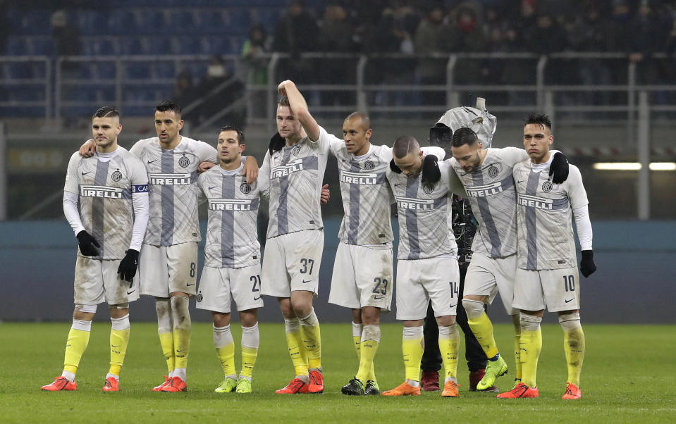 Inter players stand on the field during a shootout in an Italian Cup quarterfinal soccer match between Inter Milan and Lazio at the San Siro stadium, in Milan, Italy, Thursday, Jan. 31, 2019. (AP Photo/Luca Bruno)