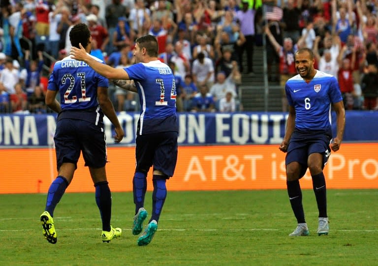 Timmy Chandler (L) of the US is congratulated by teammates Greg Garza (C) and John Brooks after scoring a goal against Guatemala during their international friendly match at Nissan Stadium in Nashville, Tennessee, on July 3, 2015