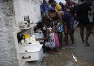 Relatives of Emily Victoria Silva dos Santos, 4, and Rebeca Beatriz Rodrigues dos Santos, 7, mourn during their burial at a cemetery in Duque de Caxias, Rio de Janeiro state, Brazil, Saturday, Dec. 5, 2020. Grieving families held funerals for Emily and Rebeca, killed by bullets while playing outside their homes. Weeping and cries of “justice” were heard Saturday at their funerals, reflecting the families’ assertion that the children were killed by police bullets. (AP Photo/Silvia Izquierdo)