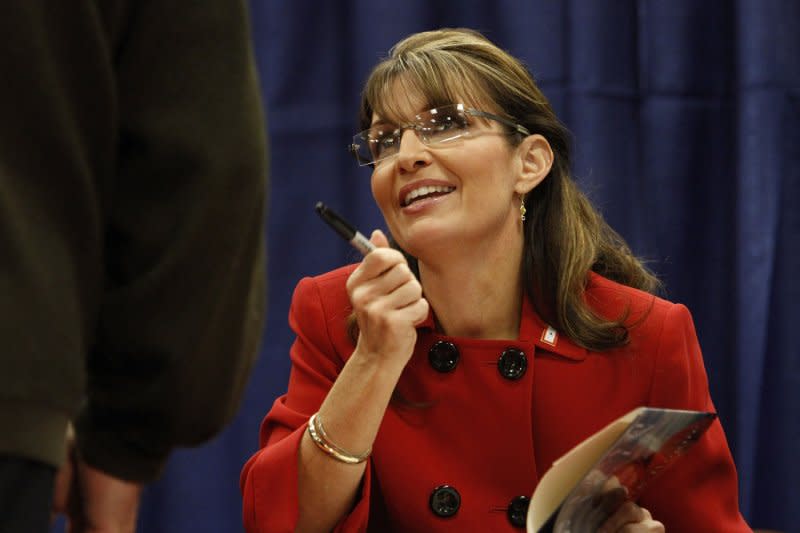 Former Alaska Gov. Sarah Palin talks with a customer at a signing for her new book "Going Rogue: An American Life" at the Woodland Mall Barnes & Noble in Grand Rapids, Mich., on November 18, 2009. On July 3, 2009, Palin announced she was resigning as governor of Alaska with 17 months to go in her term. File Photo by Brian Kersey/UPI