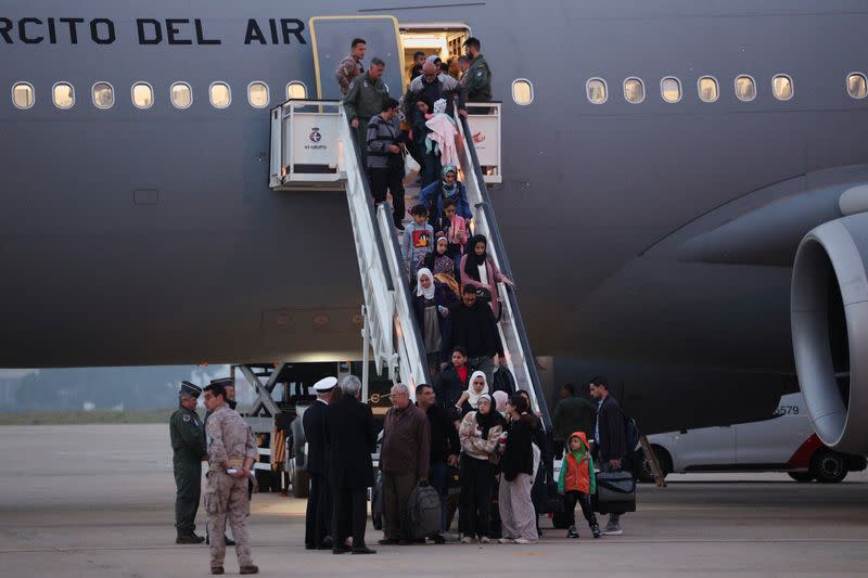 Spanish-Palestinians and Palestinians evacuated from Gaza arrive at a military base outside Madrid