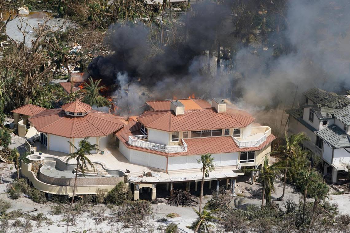 A home burns on Sanibel Island in the wake of Hurricane Ian, Thursday, Sept. 29, 2022, in Fla. (AP Photo/Wilfredo Lee)