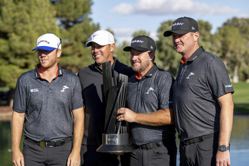 First-place team champions Captain Brooks Koepka, of Smash GC, Jason Kokrak, Graeme McDowell and Talor Gooch pose with the trophy after the final round of LIV Golf Las Vegas at Las Vegas Country Club, Saturday, Feb. 10, 2024, in Las Vegas. (Montana Pritchard/LIV Golf via AP)