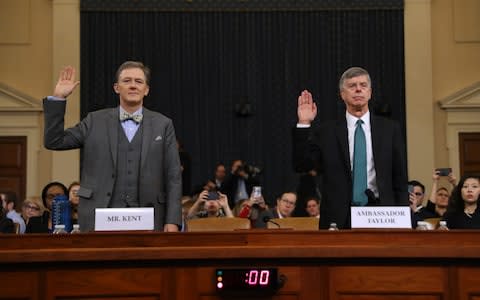 US diplomats George Kent, left, and Bill Taylor being sworn in ahead of the first day of public impeachment hearings - Credit: Chip Somodevilla/Getty Images