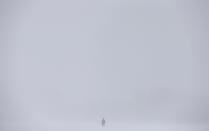 A pedestrian walks on the Plains of Abraham during a snowstorm in Quebec City, December 15, 2013. Between 15 and 30cm of snow are expected to fall on the different regions of eastern Canada today according to Environment Canada. REUTERS/Mathieu Belanger (CANADA - Tags: ENVIRONMENT)