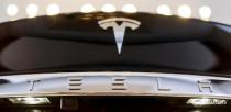 A Tesla logo adorns a 'Model S' car in the dealership in Berlin, Germany, November 18, 2015. REUTERS/Hannibal Hanschke
