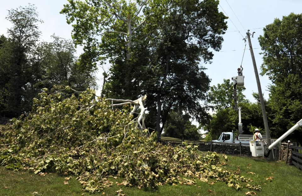 Gulf Power linemen, of Pensacola, Fla., work to repair damaged power lines in Middleburg, Va., Tuesday, July 3, 2012. Severe storms swept through the area leaving many homes and businesses without electricity. (AP Photo/Cliff Owen)