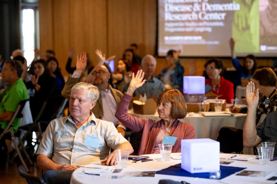 People raise their hands to share that they have had someone in their life with Alzheimer’s during an event hosted by Utah State University’s Alzheimer’s Disease and Dementia Research Center at Gallivan Hall in Salt Lake City on Thursday, Sept. 28, 2023. | Spenser Heaps, Deseret News