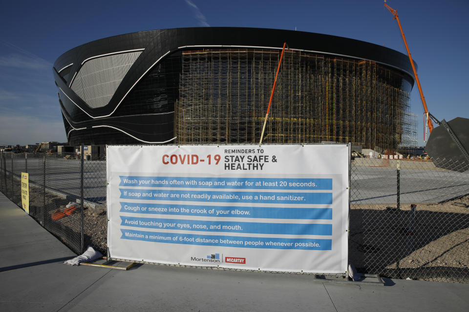 As workers fall ill and Las Vegas sits still, construction continues as Allegiant Stadium. (AP Photo/John Locher)