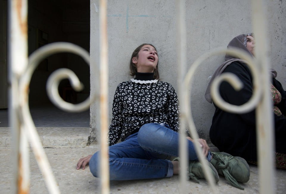 Mourners cry during the funeral of Palestinian Mohammed Shreteh, in the West Bank village of Mazraa al-Gharbiya, near Ramallah, Sunday, Nov. 11, 2018. Shreteh succumbed to his wounds that were sustained during clashes with Israeli soldiers in the village last month. (AP Photo/Nasser Nasser)