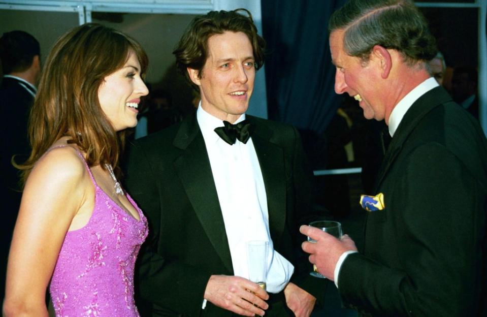 Hurley was well known for her long-term relationship with Hugh Grant (center). RICHARD YOUNG / Rex Features