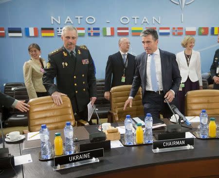 NATO Secretary General Anders Fogh Rasmussen (R) and acting Ukrainian Defence Minister Mikhail Koval (L) take their seats during a meeting at North Atlantic Council (NATO) in Brussels June 3, 2014. REUTERS/Pablo Martinez Monsivais/Pool
