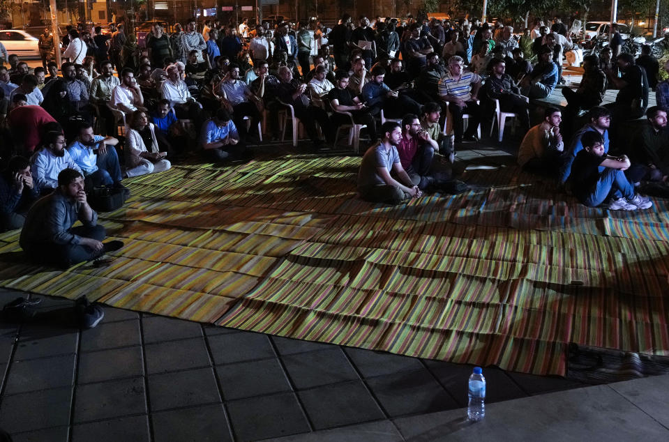 People watch a candidate debate for the June 28 presidential election on a giant screen in downtown Tehran, Iran, Monday, June 17, 2024. The election comes at a time of heightened tensions between Iran and the West over its arming of Russia in that country's war on Ukraine. (AP Photo/Vahid Salemi)