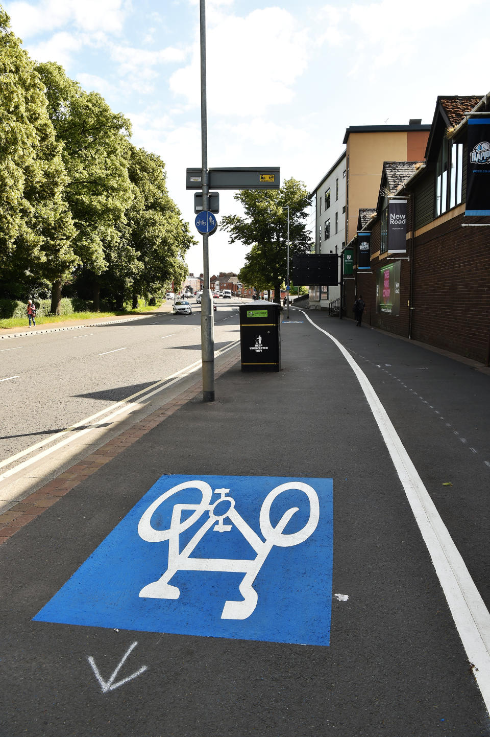 New cycle lane along New Road in Worcester from the city centre to St John's alongside Worcestershire Cricket Ground has various obstacles to navigate including a speed camera, bins and trees, all in the way of the route.  See SWNS story SWMDcycle.  June 21, 2022.  A cycle lane that is littered with obstacles including a speed camera, rubbish bins, trees and lampposts has been branded “insane”.  The barmy bike route in Worcester forces cyclists to zig-zag around numerous hazards.  On one stretch which is next to a busy main road, cyclists have to negotiate a speed camera and a lamppost which is blocking the lane.  The cycle lanes, which stretch 20 miles through Worcester, are part of a multi-million project aimed at encouraging people to cycle more.  Worcestershire County Council has installed a new segregated cycle lane along the busy New Road in Worcester as part of a pilot scheme.  But cyclists blasted the lane, saying it is “more dangerous than cycling on the road”. 