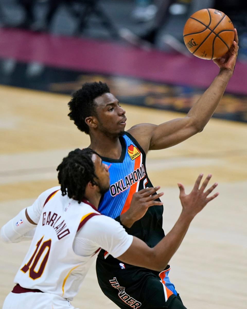 Oklahoma City Thunder's Hamidou Diallo, right, drives to the basket against Cleveland Cavaliers' Darius Garland during the second half of an NBA basketball game Sunday, Feb. 21, 2021, in Cleveland. (AP Photo/Tony Dejak)