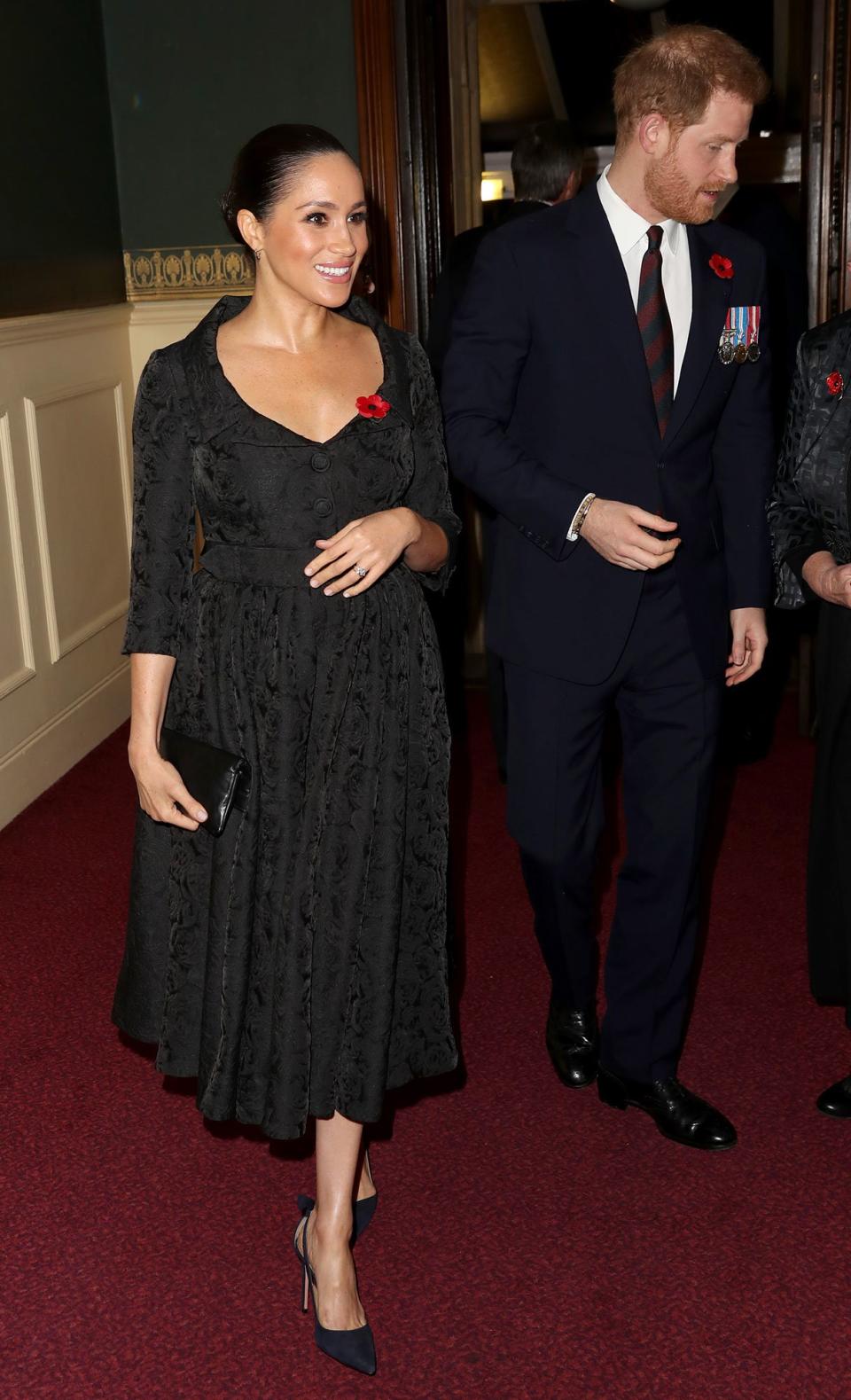 in a custom Erdem black brocade dress with Jessica McCormack hoop earrings, black Aquazzura bow-adorned pumps, and the traditional red poppy pin at the annual Royal British Legion Festival of Remembrance in London.