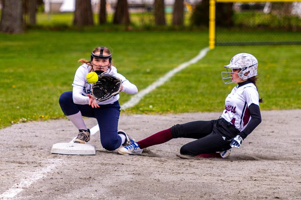 Old Colony's Madeline Bonneau slides safely into third as Bristol-Plymouth's Victoria D'Aiello attempts to block the bag while awaiting the throw.