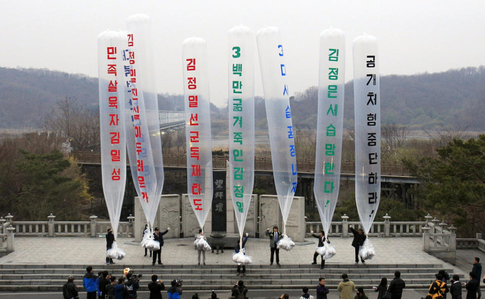 Park Sang-hak, center, a refugee from North Korea who runs the group Fighters for a Free North Korea, and South Korean activists prepare to release balloons bearing leaflets during an anti-North Korea rally near the border village of Panmunjom in Paju, South Korea, on April 15, 2011.<span class="copyright">Lee Jin-man—AP</span>