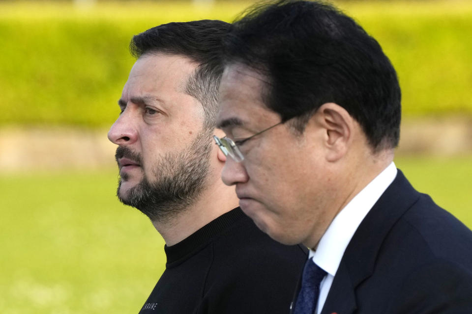 Ukrainian President Volodymyr Zelenskyy, left, is escorted by Japanese Prime Minister Fumio Kishida to the Cenotaph for the Victims of the Atomic Bomb at the Hiroshima Peace Memorial Park after he was invited to the Group of Seven (G7) nations' summit in Hiroshima, western Japan Sunday, May 21, 2023. (AP Photo/Eugene Hoshiko, Pool)
