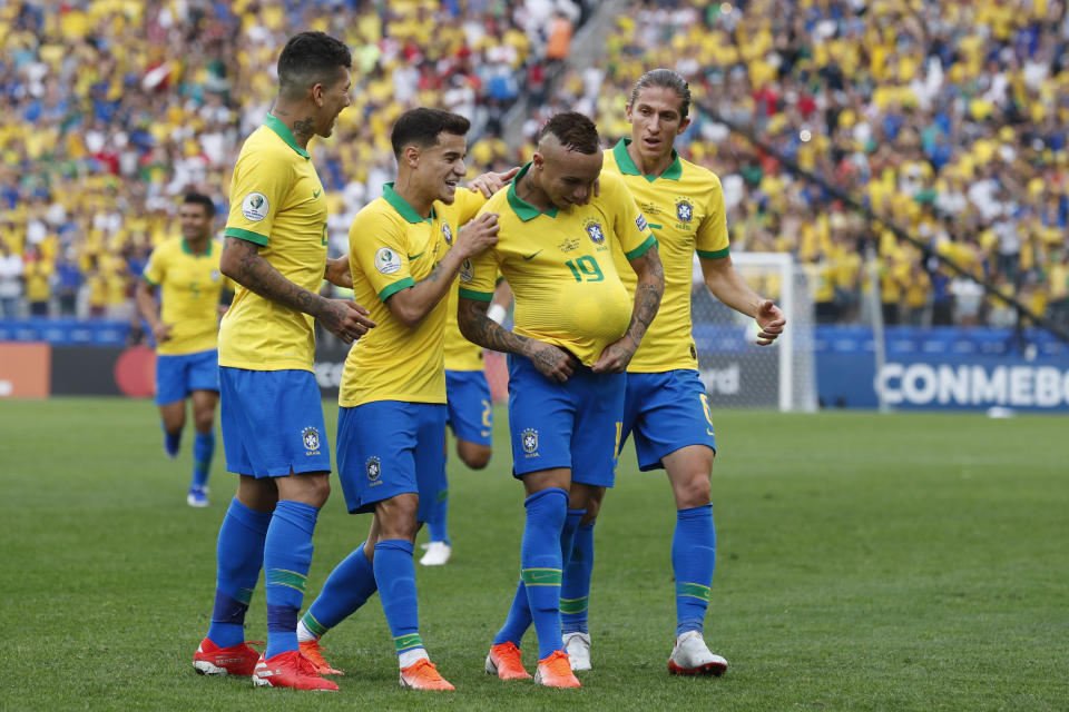 Teammates congratulate Brazil's Everton, with the ball under his jersey, after he scored his side's third goal against Peru during a Copa America Group A soccer match at the Arena Corinthians in Sao Paulo, Brazil, Saturday, June 22, 2019. (AP Photo/Victor R. Caivano)