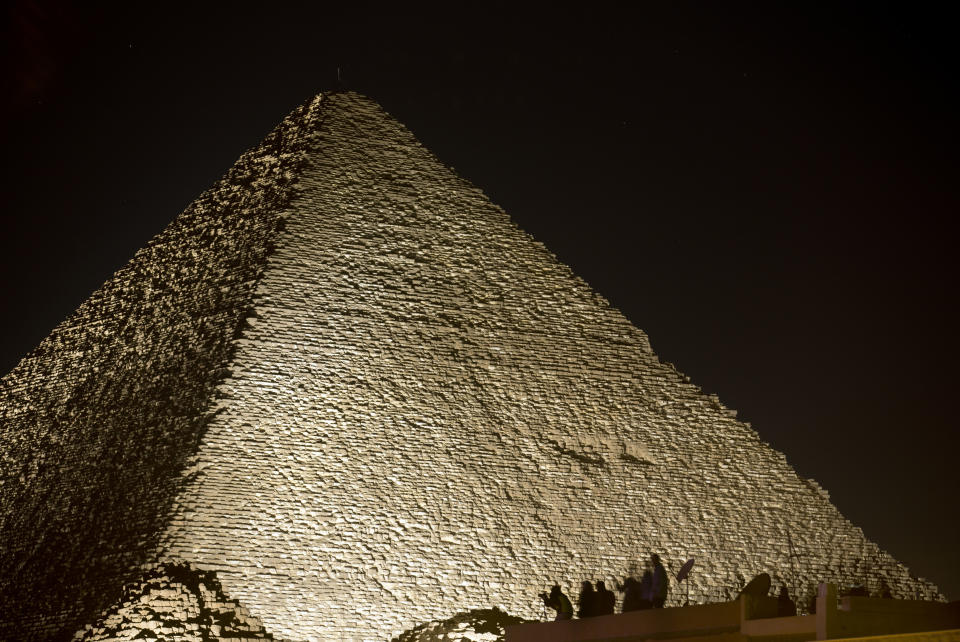 <p>Visitors film the light on the historical site of Giza Pyramids as they celebrate the New Year in Egypt, Monday, Jan. 1, 2018. (Photo: Amr Nabil/AP) </p>