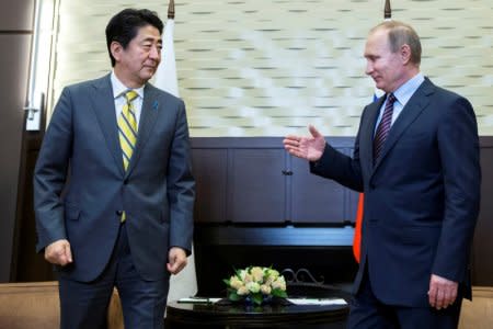 Russian President Vladimir Putin (R) meets with Japanese Prime Minister Shinzo Abe in Sochi, Russia, May 6, 2016. REUTERS/Pavel Golovkin/Pool