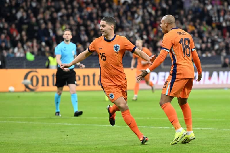 The Netherlands' Joey Veerman (L) celebrates with teammate Donyell Malen after scoring his side's first goal during the International Friendly soccer match between Germany and Netherlands at the Deutsche Bank Park stadium. Federico Gambarini/dpa