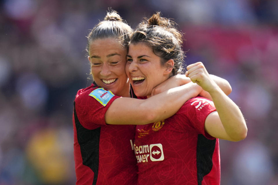 Manchester United's Lucia Garcia, right, celebrates with Maya Le Tissier after scoring her side's fourth goal during the Women's FA Cup final soccer match between Manchester United and Tottenham Hotspur at Wembley Stadium in London, Sunday, May 12, 2024. (AP Photo/Kirsty Wigglesworth)