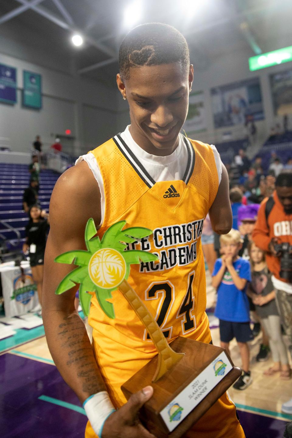 Life Christian's Hansel Enmanuel Donato (24) celebrates after winning the 2021 City of Palms Classic Edison Bank SLAM DUNK Contest, Sunday, Dec. 19, 2021, at Suncoast Credit Union Arena in Fort Myers, Fla.