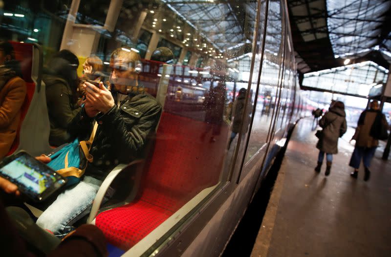 Commuters wait for departure of a local train at Gare Saint-Lazare train station