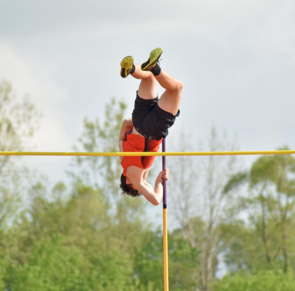 Quincy's Corey Turner clears a big height in the pole vault on his way to a win on Friday