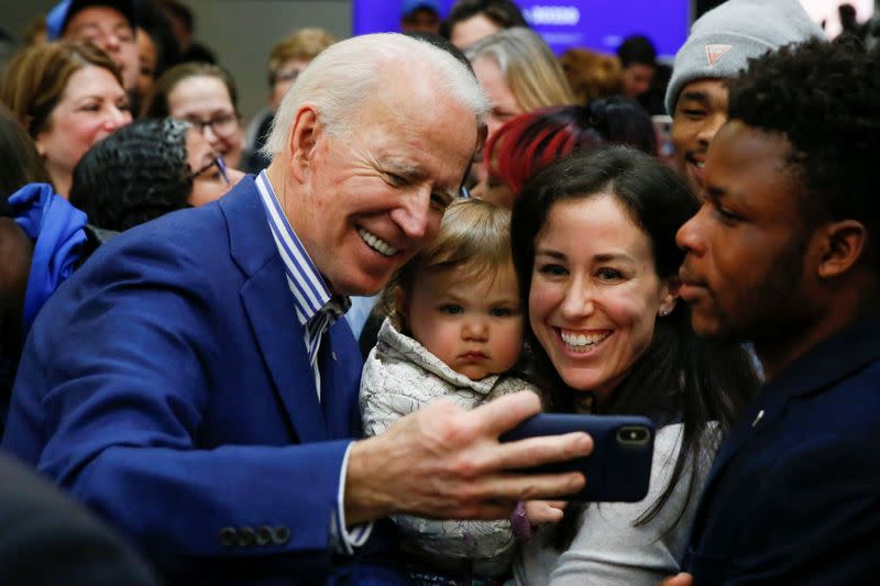 Democratic U.S. presidential candidate and former U.S. Vice President Joe Biden takes photos with audience members at the end of a campaign event at Saint Augustine's University in Raleigh