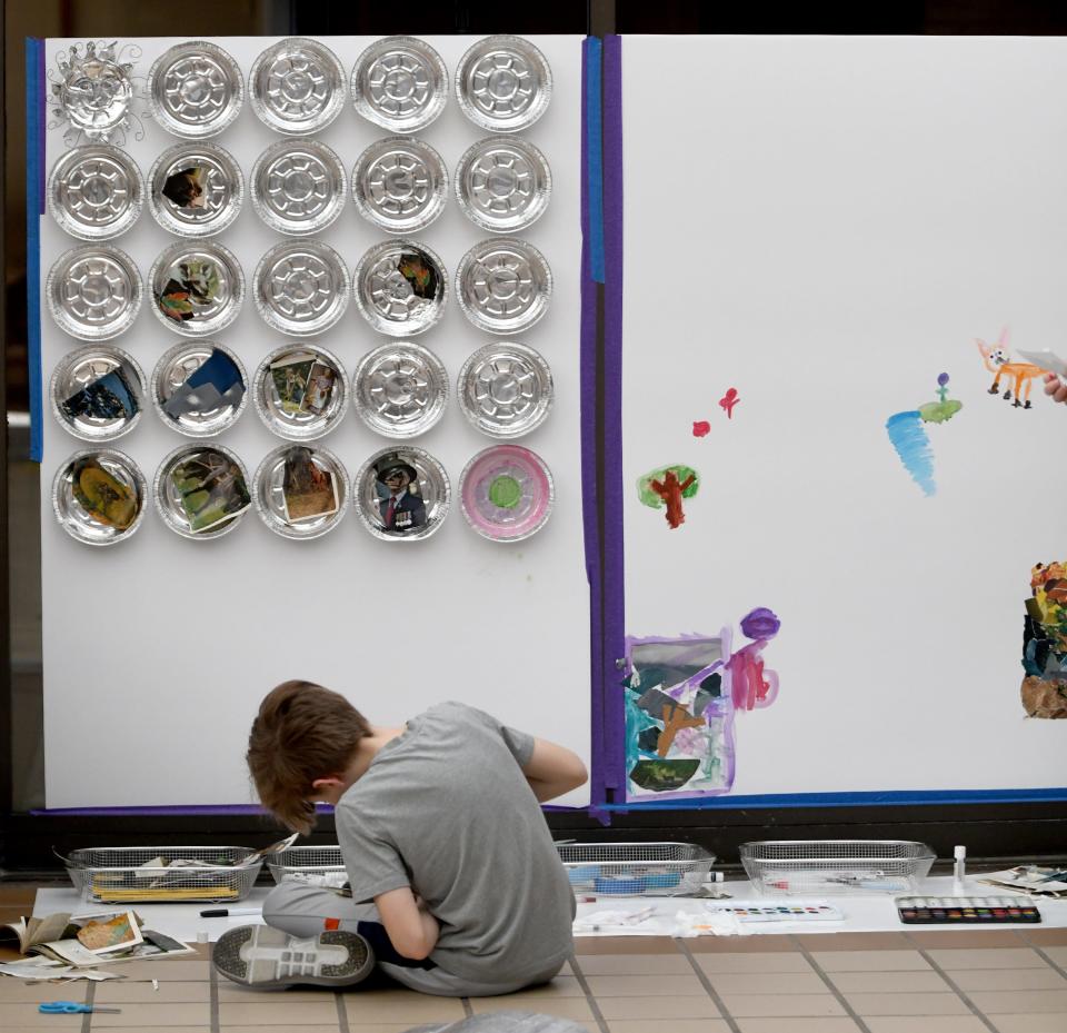 Liam Flanders, 12, of North Canton helps to create a mural, part of "Go Big! WPA Mural Artist Celebration" during School's Out Free Mondays event at the Canton Museum of Art.