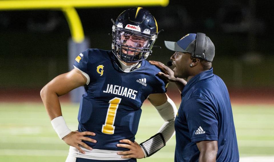 Gregori’s coach Lamar Wallace talks with quarterback Conner Bailey during the nonleague game with Livermore at Gregori High School in Modesto, Calif., Friday, September 8, 2023.