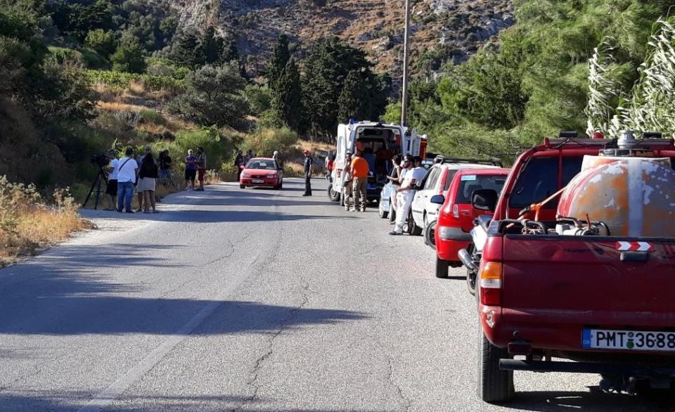 Authorities and residents gather near the location where police said the body of Cyprus-based astrophysicist Natalie Christopher, 34, was found in a 20-meter-deep ravine, in Faros village on the Greek island of Ikaria, Wednesday, Aug. 7, 2019. Greek authorities say search crews have found the body of a British scientist who went missing while on holiday on the Aegean island of Ikaria in a ravine near where the woman had been staying. (Nikos Litsardis/ikariaki.gr via AP)