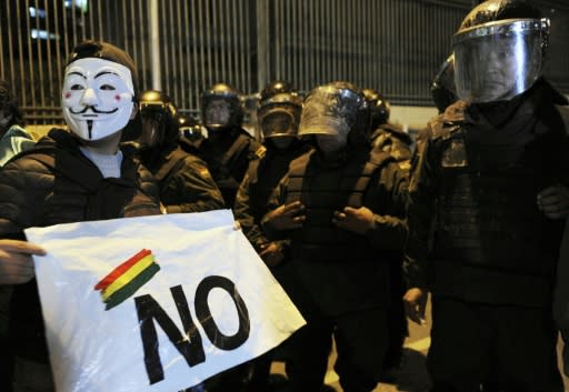 A supporter of Bolivia's presidential candidate Carlos Mesa in front of riot police during a protest over the disputed vote count