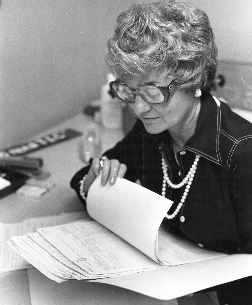 Day Nursery of Abilene director Bea Ganson poring over paperwork.