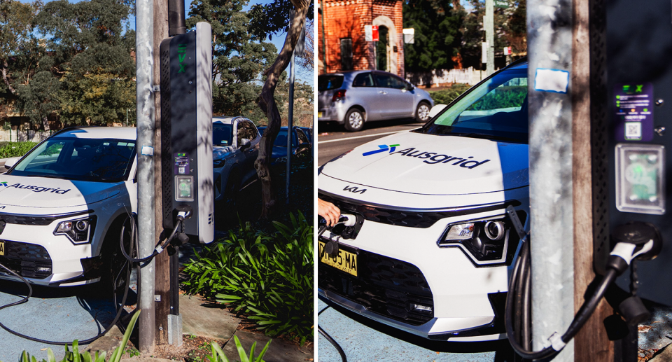 Ausgrid's Nick Black uses a new EV charger station, mounted directly onto a power pole in Sydney. 