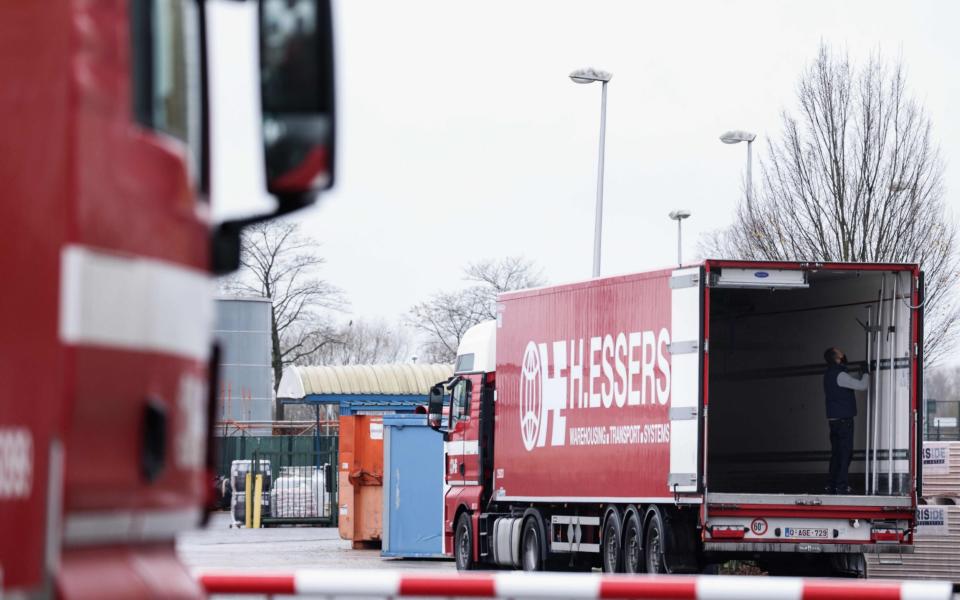 Trucks are loaded at a factory of US multinational pharmaceutical company Pfizer, in Puurs, where Covid-19 vaccines are being produced for Britain - AFP