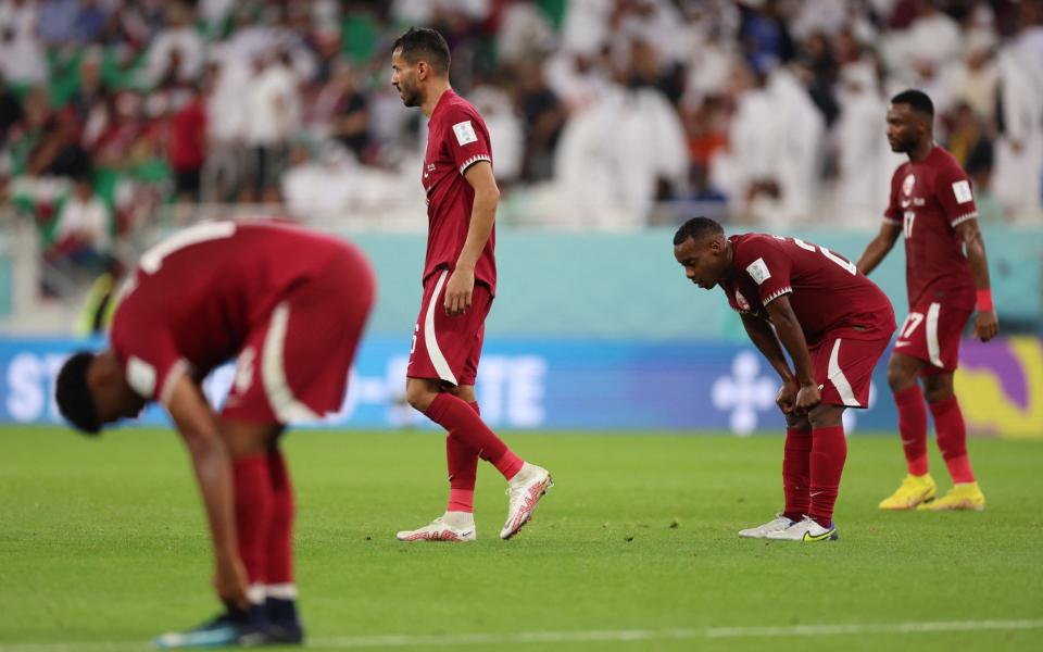 Qatar's Boualem Khoukhi and Assim Madibo react - Reuters