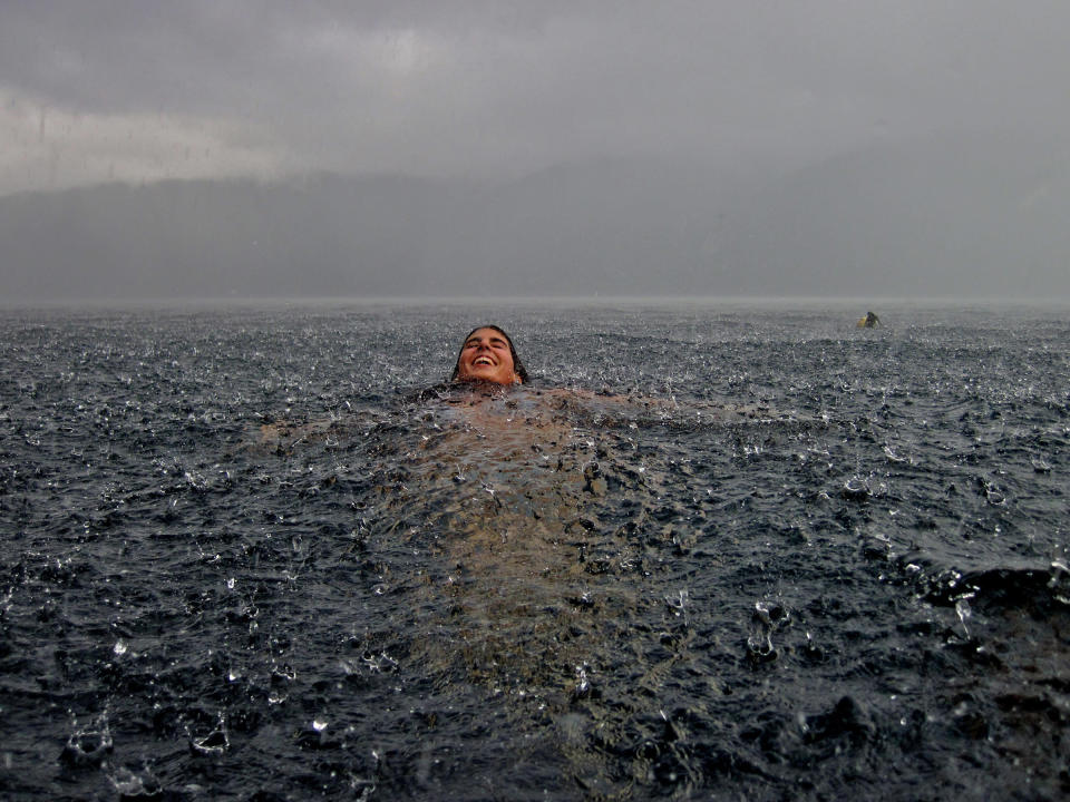 Merit Winner: My sister in the south of Chile. We are sitting at home next to the fireplace in our southern lake house when it suddenly began to pour uncontrolably. Had to rush into the lake to take this snapshot! (Photo and caption by Camila Massu/National Geographic Traveler Photo Contest) <br> <br> <a href="http://travel.nationalgeographic.com/travel/traveler-magazine/photo-contest/2012/entries/gallery/winners/" rel="nofollow noopener" target="_blank" data-ylk="slk:Click here to see the National Geographic Traveler's Winners Gallery;elm:context_link;itc:0;sec:content-canvas" class="link ">Click here to see the National Geographic Traveler's Winners Gallery</a>